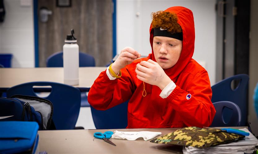 Students practice sewing